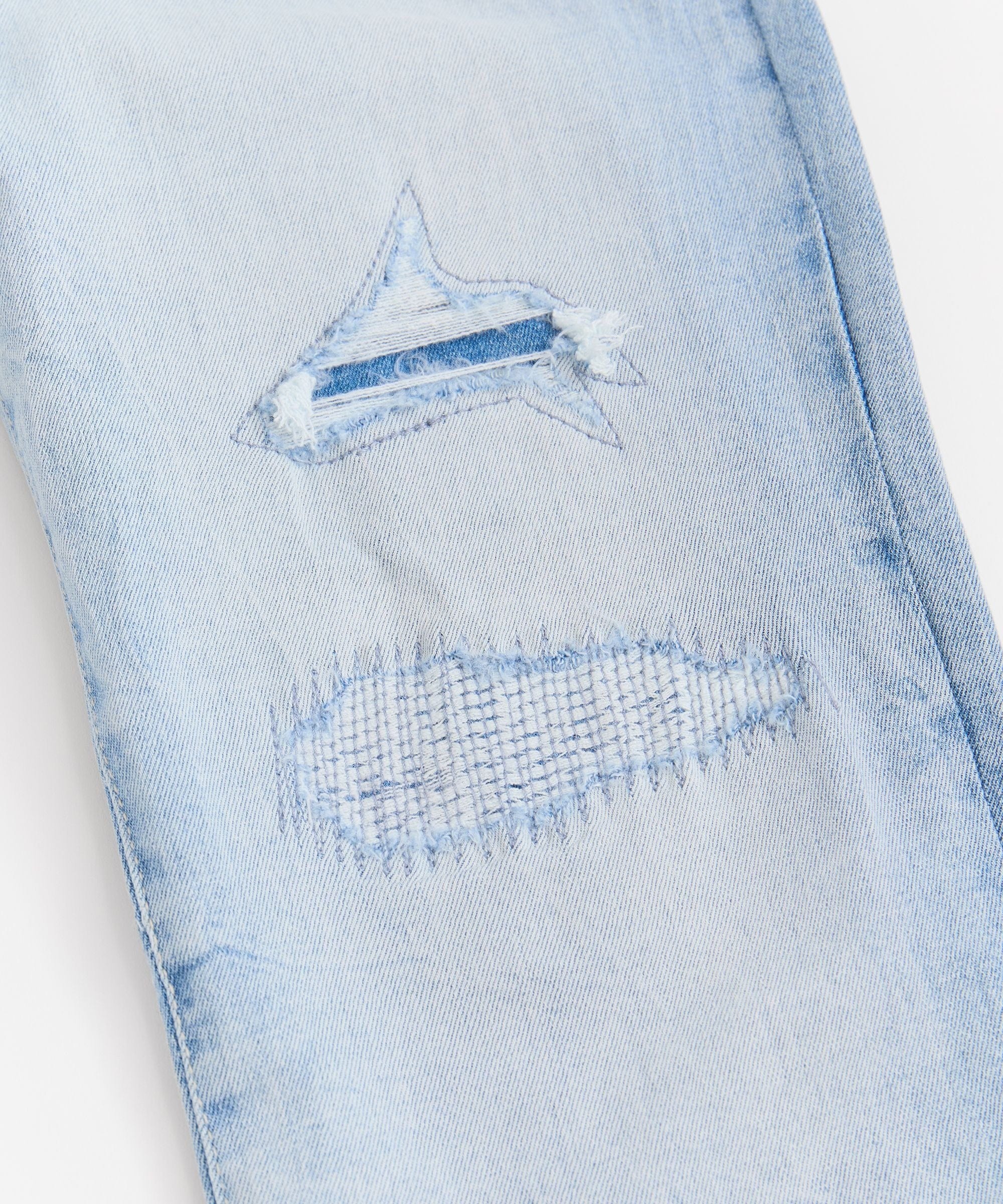 Rip And Repair Light Wash Denim Jeans - Image 4
